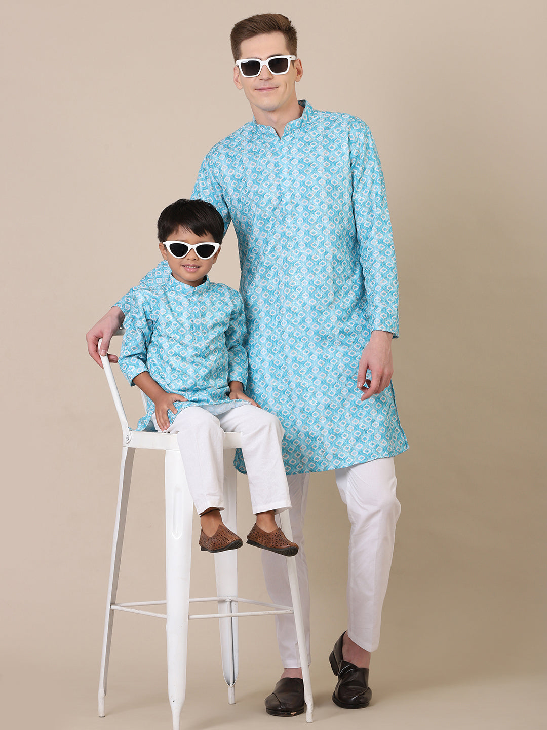 "Father and son wearing matching sky blue printed cotton kurta pajama combo set with white churidar, stylish twinning outfit for family celebrations, Diwali, weddings, and festive ethnic wear."