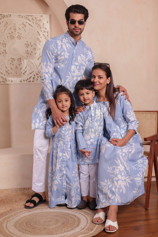 Soft cotton family combo dress set in pastel blue with floral print, featuring men’s kurta, women’s long dress, boy’s kurta, and girl’s flared dress — perfect for full family twinning in comfort and style