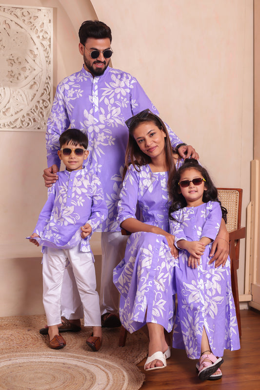 Lavender floral print family combo dress set featuring mom in a long cotton dress, dad in a lavender kurta-pyjama, and kids in coordinated outfits. Perfect family matching outfits for festive twinning, photoshoots, or vacations. Soft cotton fabric with elegant floral patterns.