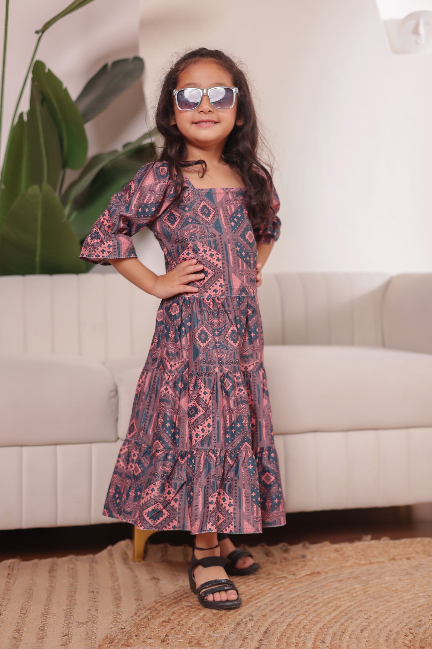 "Daughter in a cute cotton printed dress—matches the family combo collection for twinning with mom or dad."
