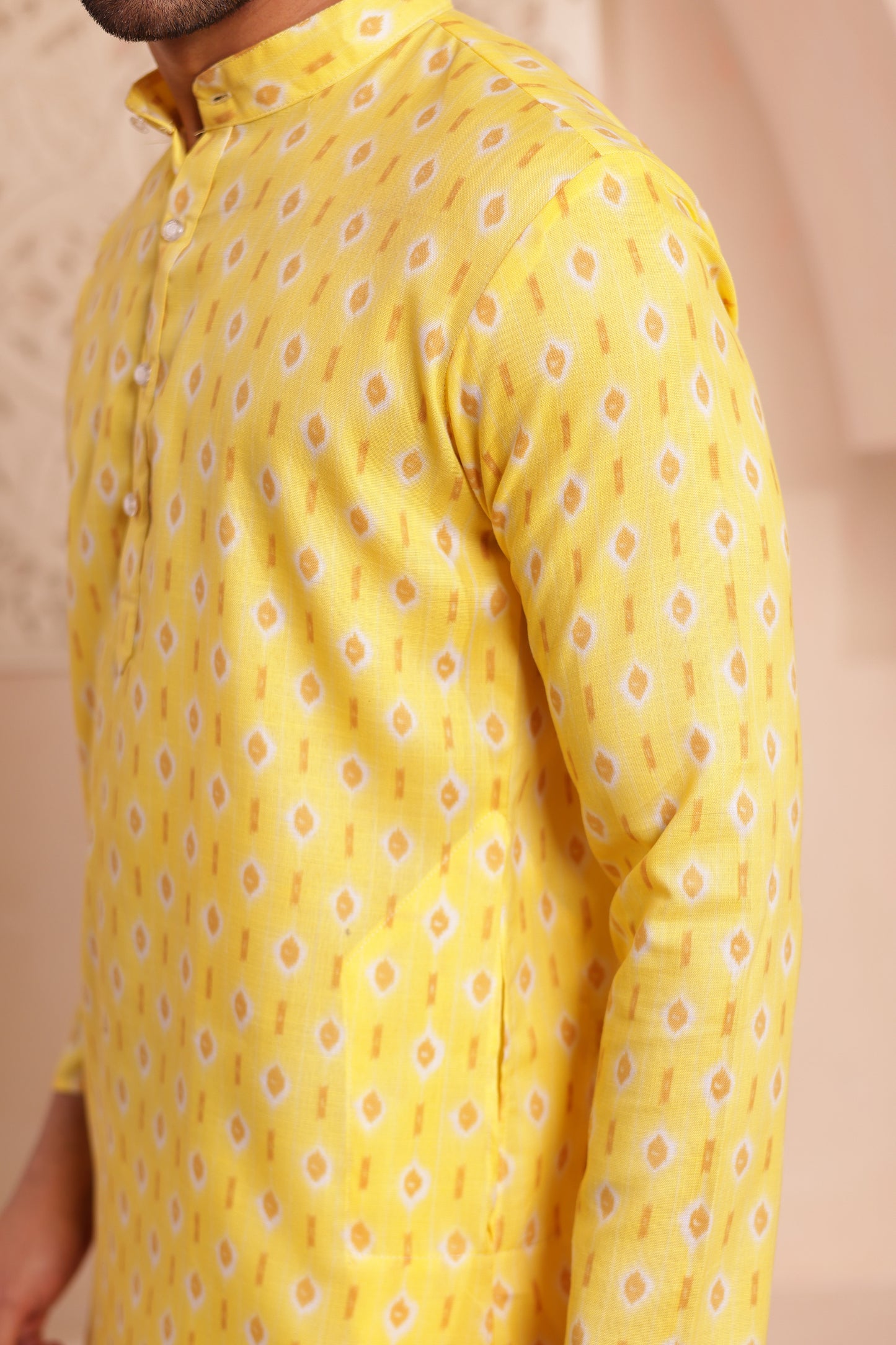 Men’s yellow kurta pajama in soft cotton with subtle floral prints. Traditional yet stylish outfit for Haldi, poojas, and festive occasions.
