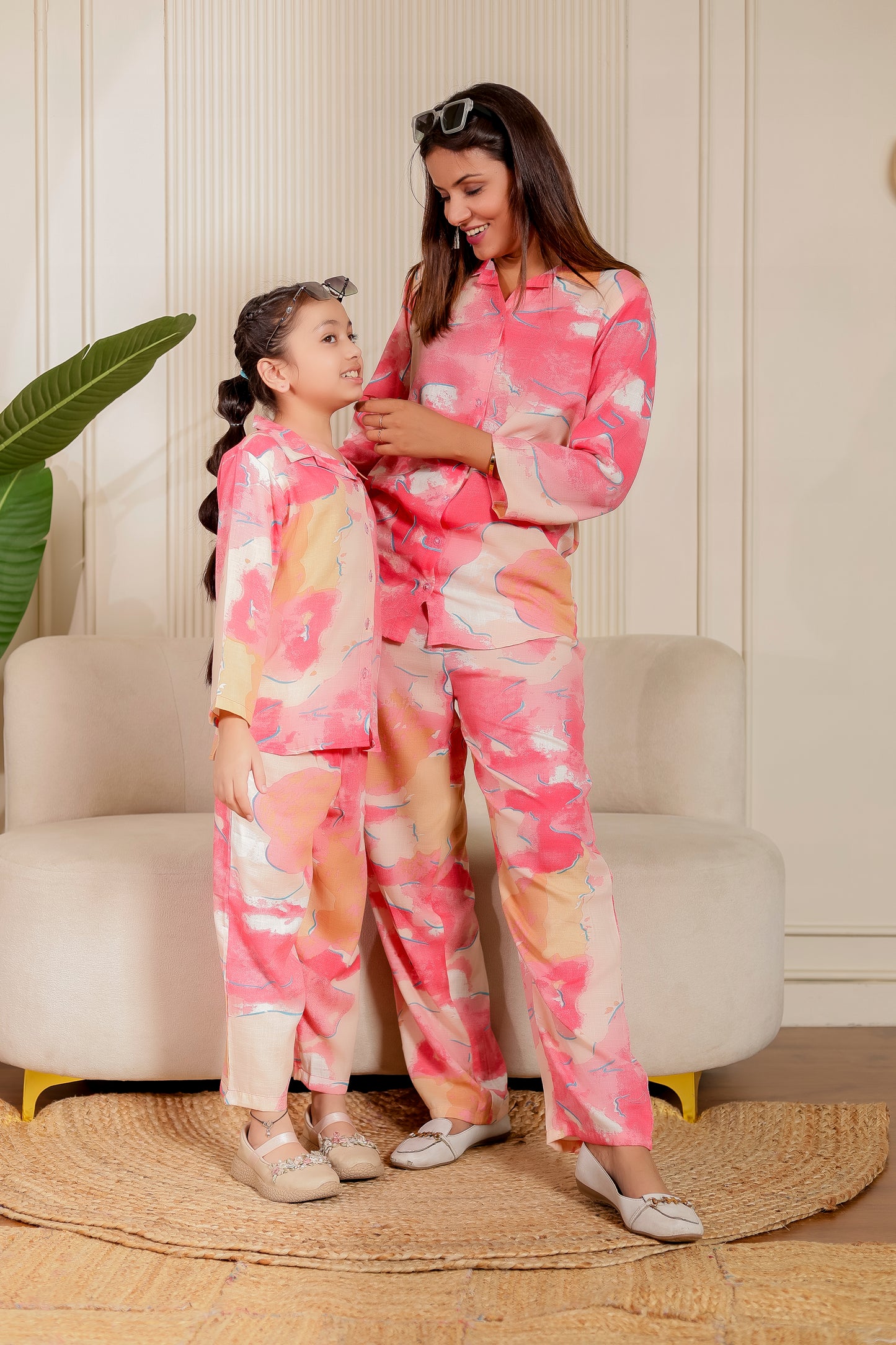 Mother and daughter wearing coordinated co-ord sets in pink abstract cotton print. Perfect mother-daughter matching outfit for casual or festive occasions.