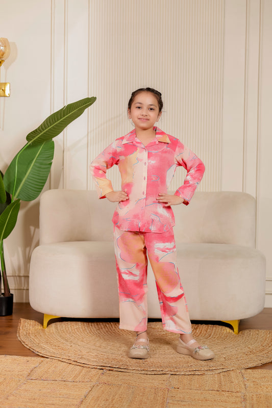 Young girl in a vibrant pink abstract co-ord set from the Bubblegum Bliss combo. Cute and comfortable cotton outfit for twinning or festive fun.