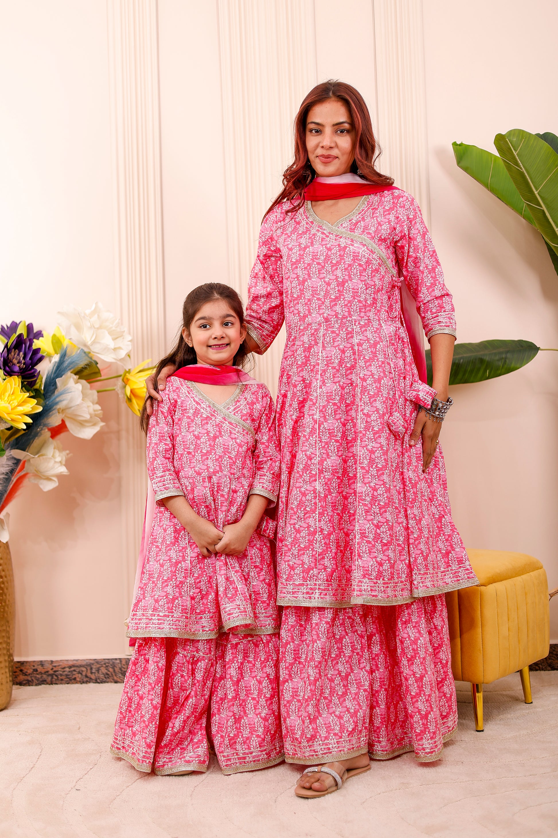 “Mother and daughter wearing royal pink matching combo outfits in twinning style”