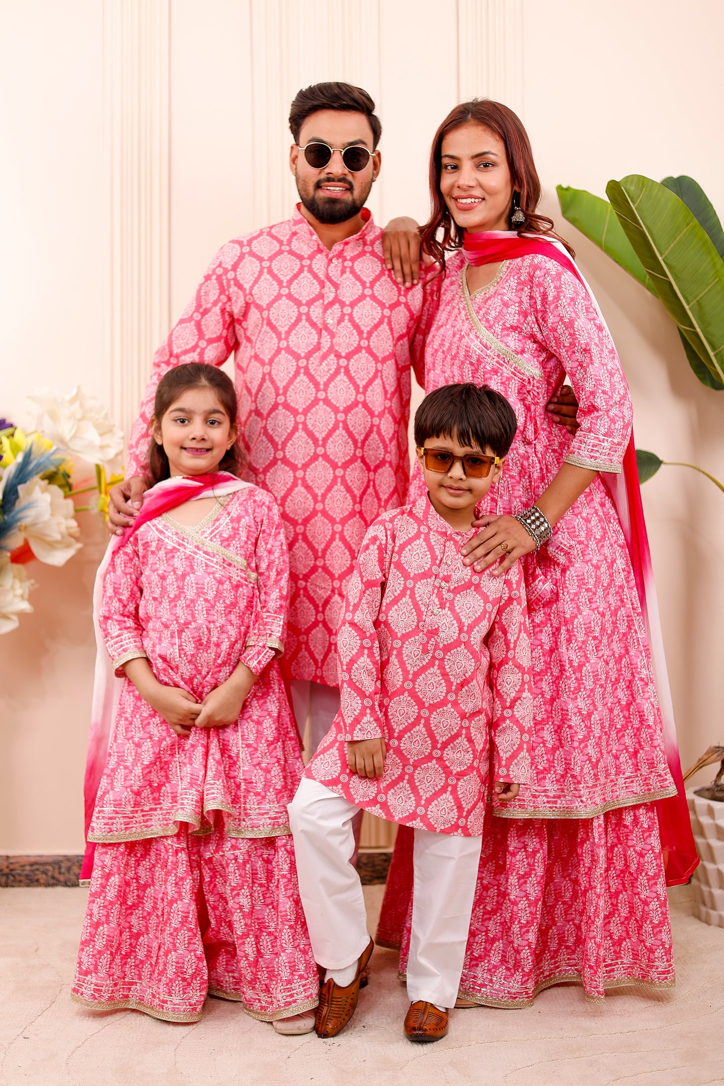 “Family wearing royal pink matching combo outfits for twinning look”