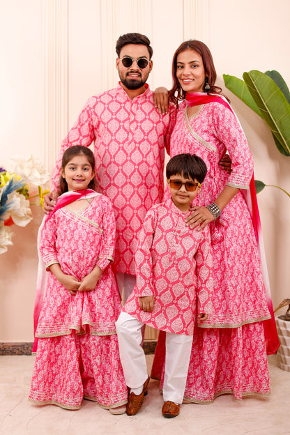 “Family wearing royal pink matching combo outfits for twinning look”