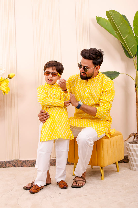 Father and son in bright yellow twinning outfits – matching kurta-pajama set for Haldi, weddings, and festivals.
