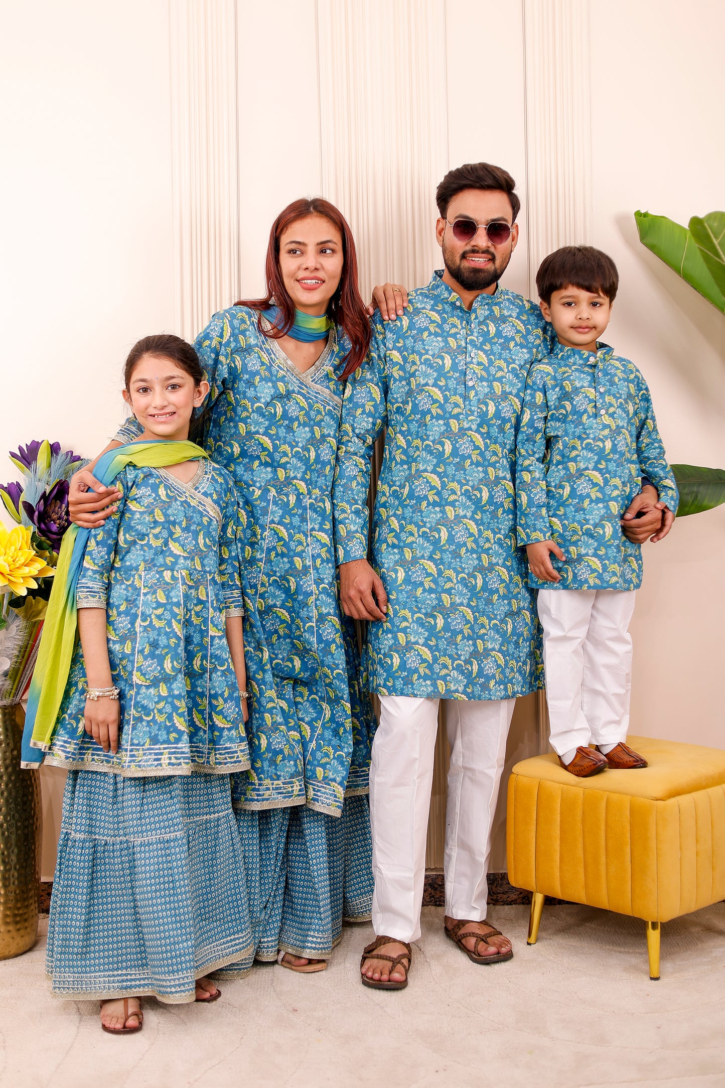 Red floral family matching outfits with coordinated designs for mom, dad, and kids, perfect for festivals, weddings, and photoshoots