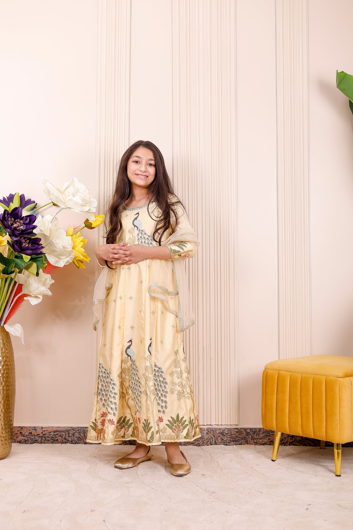Champagne yellow Anarkali for girls featuring peacock embroidery for festive matching
