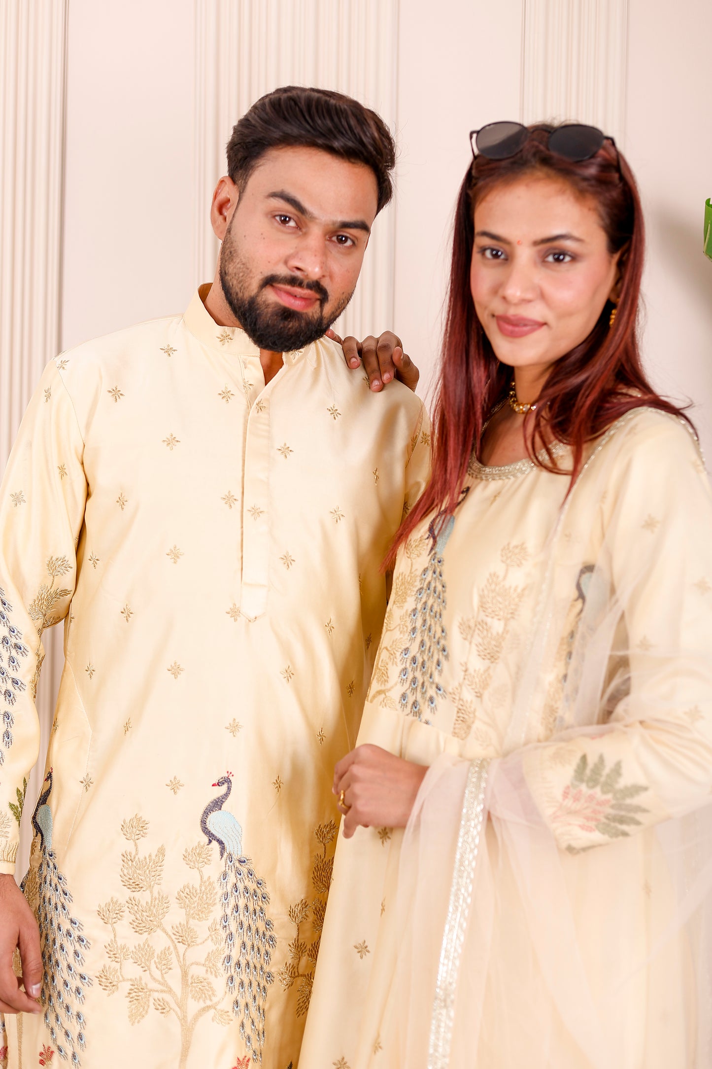 Champagne yellow peacock embroidered outfits styled as coordinated couple wear