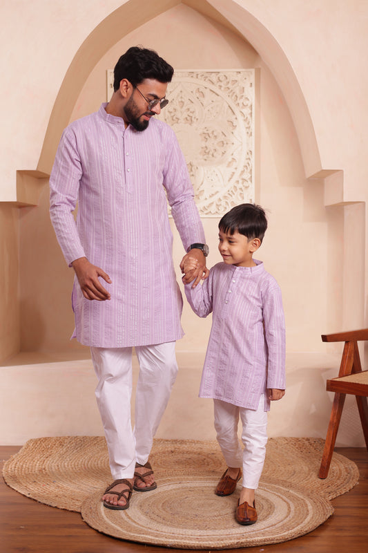 Father and son wearing matching lilac patterned kurta pajama combo set for festive occasions