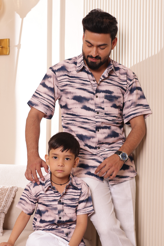 Father and son wearing Ocean Wave muted mauve and navy wave matching shirts
