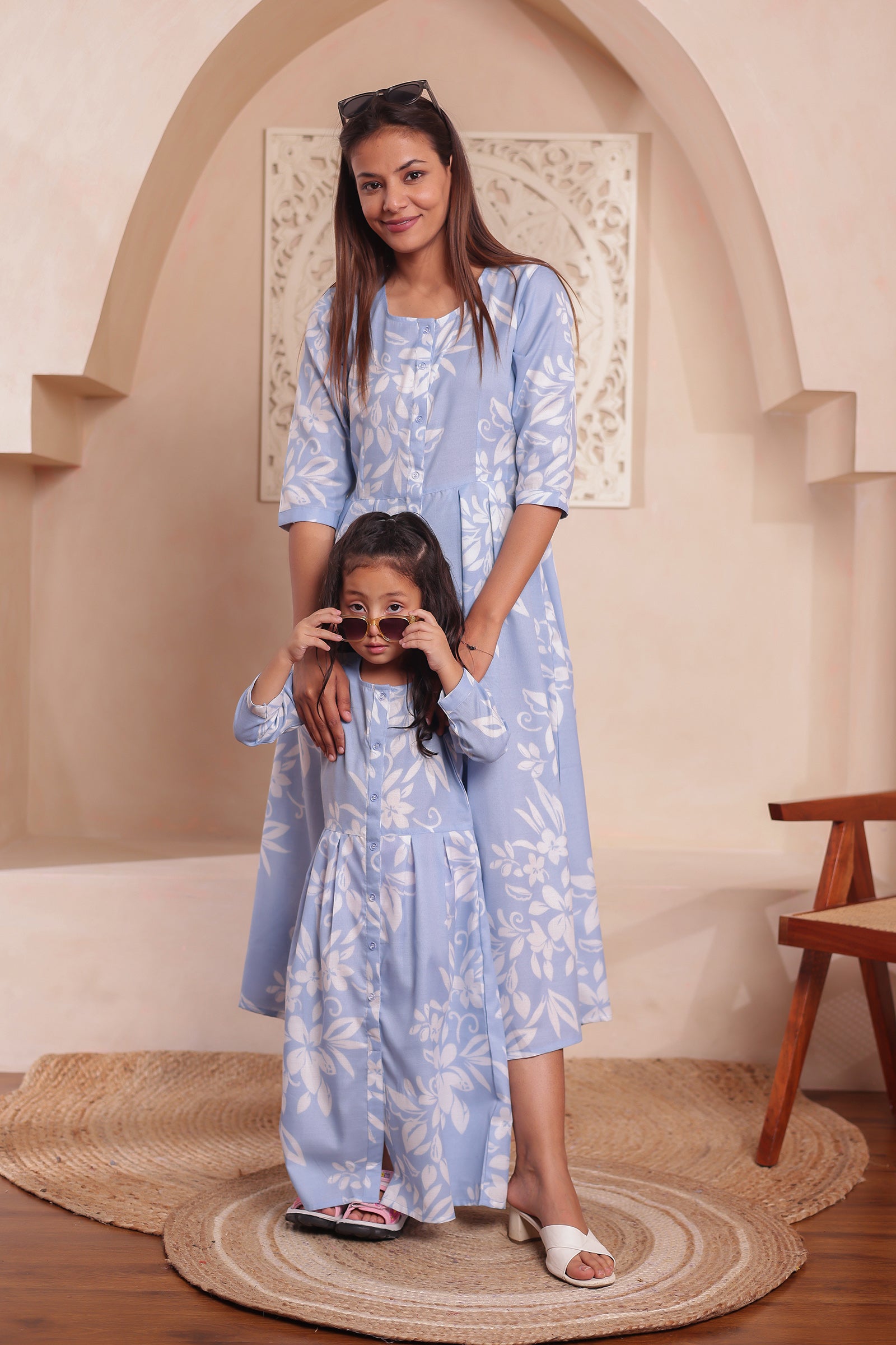 Mom and daughter twinning in pastel blue matching dress for vacation and photoshoot