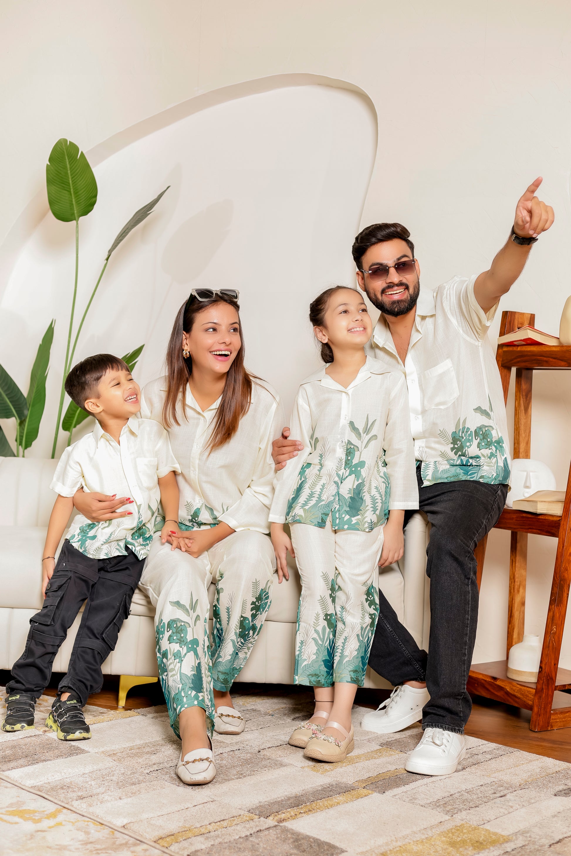 Family matching outfits and family combo dress in soft cotton with green tropical prints, featuring coordinated co-ord sets and matching shirts for mom, dad, son, and daughter.